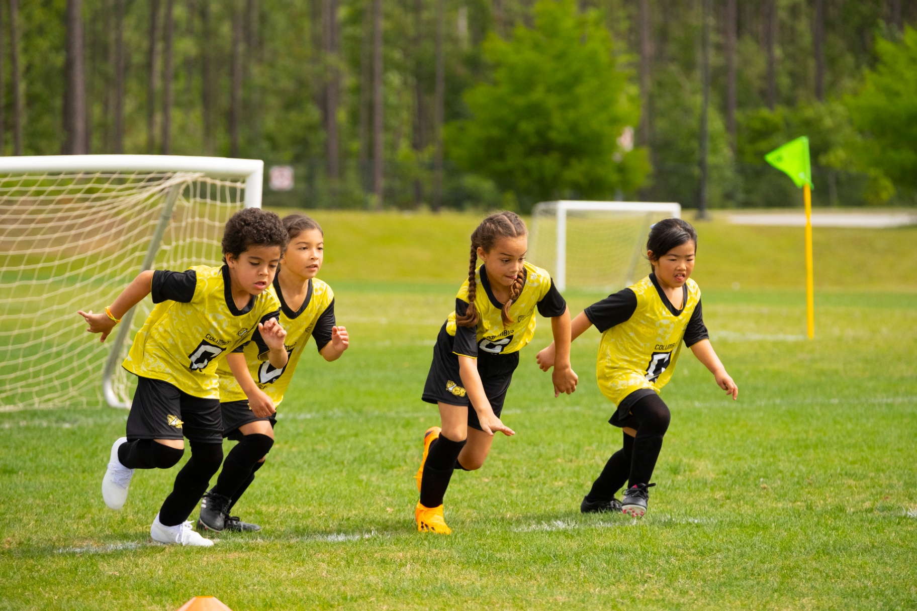 Kids sprinting from the goal at an MLS GO session