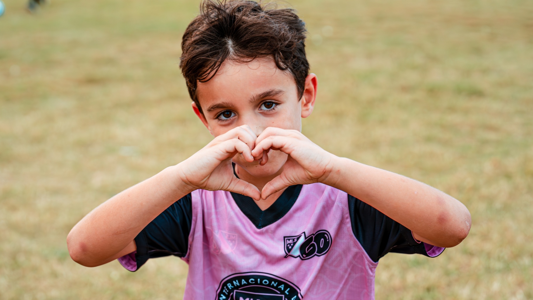 Young player making a heart with his hands