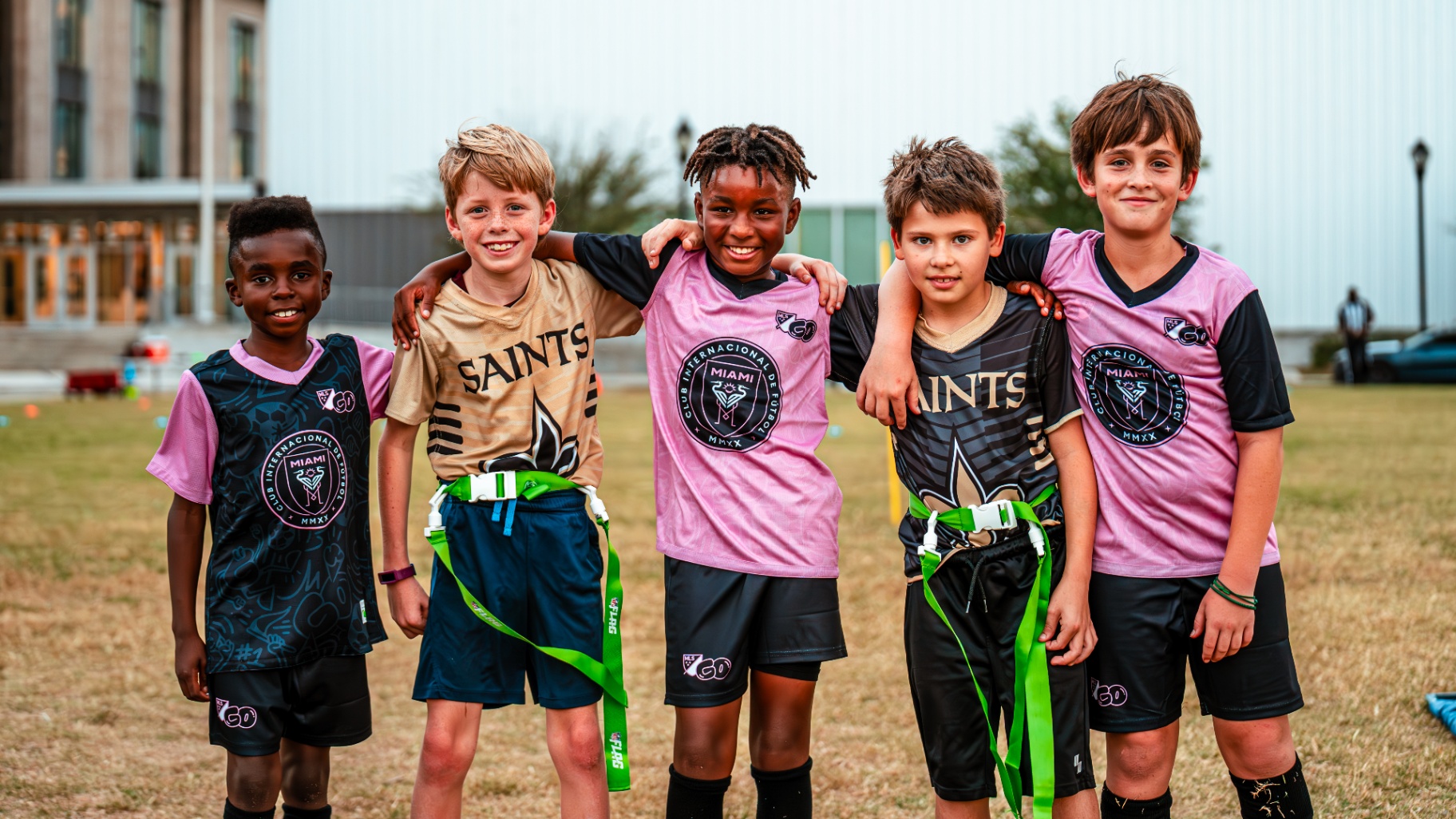 Young MLS GO players celebrating together on the field