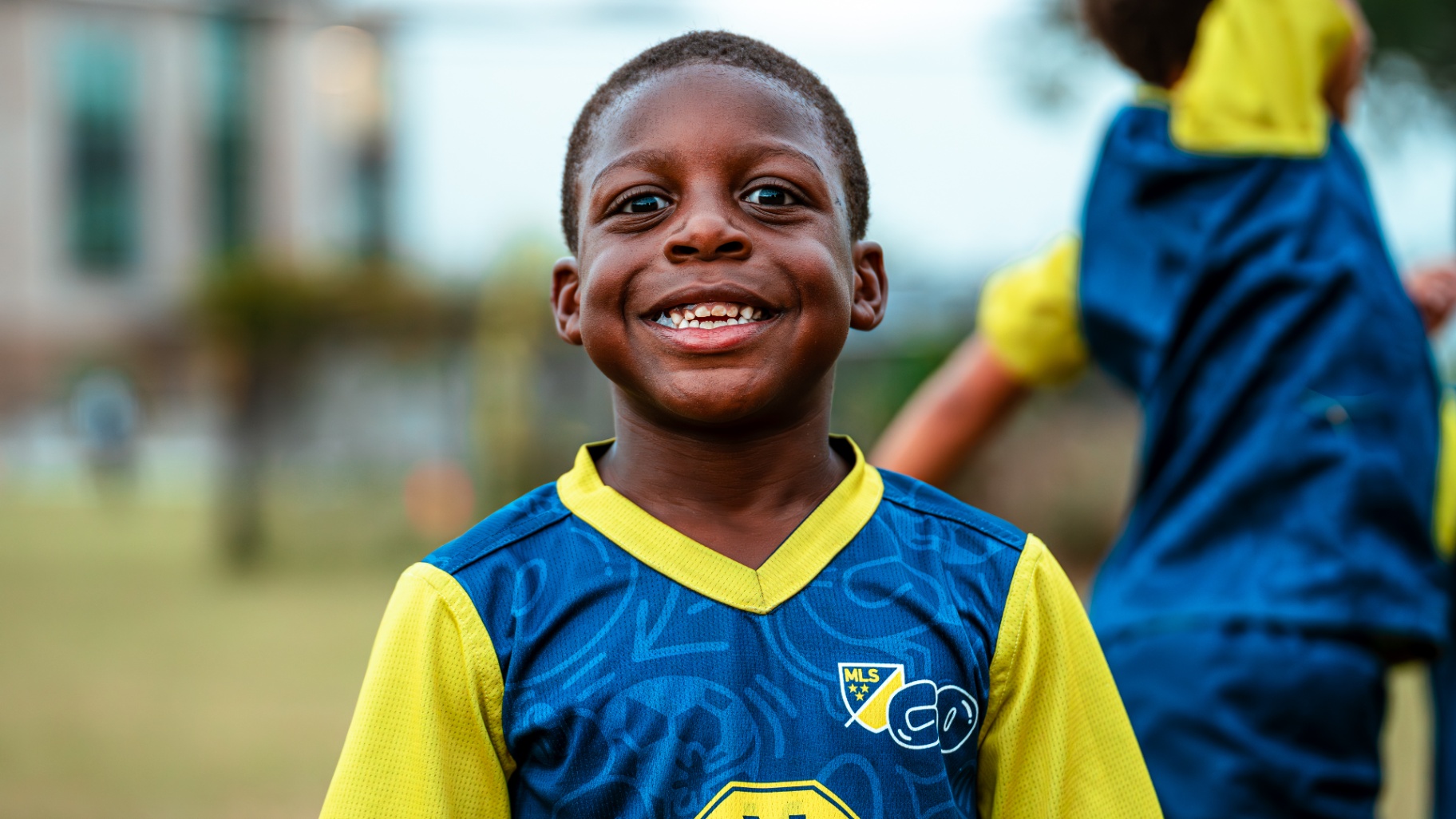 Smiling young player in MLS GO kit